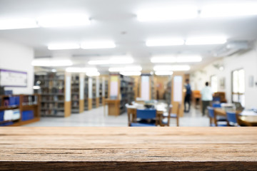 Empty wooden desk space platform with library background for product display montage. Education concept.