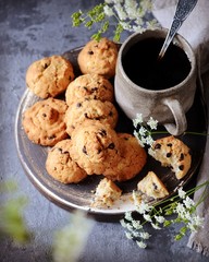 Homemade cookies with oatmeal and chocolate drops on a plate with a mug of coffee. Breakfast. Still life