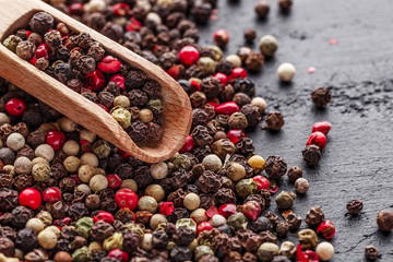 A set of peppers.Collage of different type pepper, Black ,white, pink and allspice peppercornsr, dried chili pepper.Top view. On a black background. free space for your text.