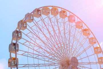Attraction ferris wheel on a background of blue sky.
