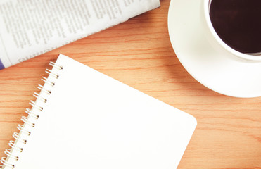 Black coffee with note paper for text on wooden desk, a simple workspace or coffee break in morning time ,business or meeting online for work at home and social distancing concept
