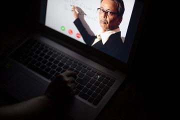 Hands pf an Indian woman on laptop keypad while attending online classes in home isolation due to corona virus. Covid-19, quarantine and lockdown. Online teaching, video lectures and tutorials