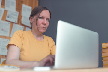 Female freelancer working from home on laptop computer