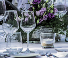 table set for candlelight dinner with flowers at the centerpiece