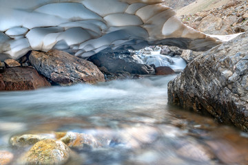 The beautiful view of frozen glacier and Kaznok river neat to Zmeya peak in Fann mountains in Tajikistan