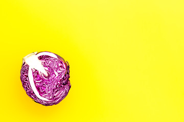 Red cabbage - head, cross section - on yellow background top view copy space