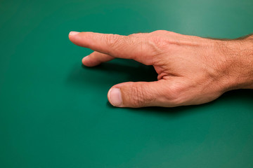 Caucasian man hand on a green background