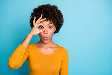 Portrait of astonished crazy afro american girl make okay sign binocular eye watch her neighbors...