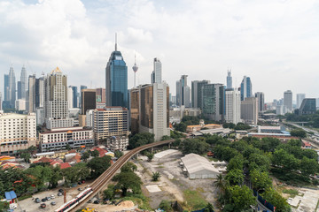 Fototapeta na wymiar Panoramic view of Kuala Lumpur skyline at day time. City center of capital of Malaysia. Contemporary buildings exterior with glass.