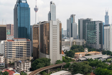 Obraz premium Panoramic view of Kuala Lumpur skyline at day time. City center of capital of Malaysia. Contemporary buildings exterior with glass.