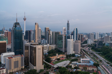Obraz premium Panoramic view of Kuala Lumpur skyline at sunset. City center of capital of Malaysia. Contemporary buildings exterior with glass.