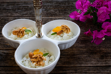 Turkish desert güllaç on the wooden rustic table.