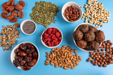 Top view collection of Superfoods in Bowls for health, fitness and vitality used for preparing energy balls.