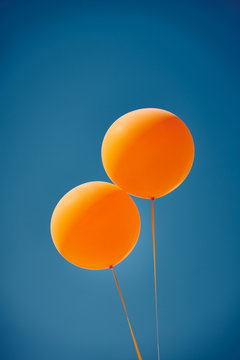 Orange Balloons Against A Blue Sky. Orange And Blue