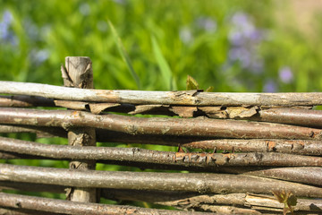 Wooden wicker fence of branches made of twigs.