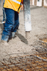 Details of construction site. worker pouring concrete with automatic pump