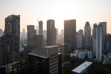 Panoramic view of Bangkok skyline at sunset. Modern city center of capital of Thailand. Contemporary buildings exterior with glass.