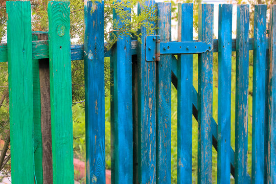 Gate and wooden fence at the cottage: country house in summer, natural harmony.