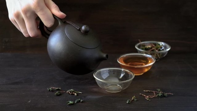 pouring chinese traditional tea ceremony on grey background