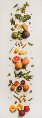 Variety of immunity boosting plant foods. Flat-lay of ginger, turmeric, kale, artichoke, citrus fruit, herbs, garlic, pepper over white background, top view. Healthy, vegan virus defeating ingredients