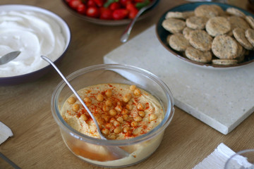 Bowl of homemade hummus served on a table. Selective focus.