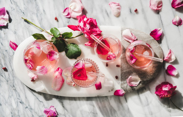 Summer refreshing cold beverage drink. Flat-lay of rose lemonade with ice cubes in glasses and...