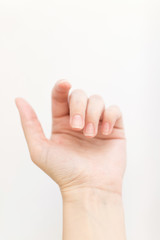 Obraz premium Close up woman hand with nails form of soft square holds something in fingers. Female keeps virtual object. Nail care at home. Copy space.