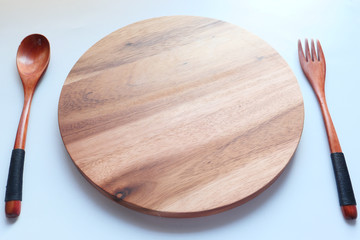 Top view of wooden chopping board on white background .