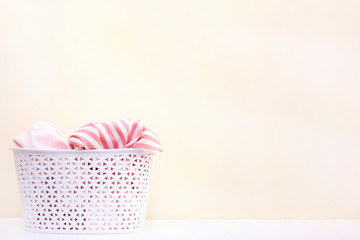 white basket with dirty linen. concept of washing clothes and home cleaning. copyspace