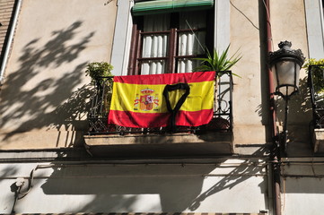 Coronavirus black ribbon on Spanish flag in Granada, Spain, Andalusia 