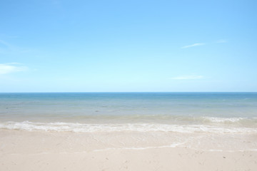 Sandy beach with the blue ocean