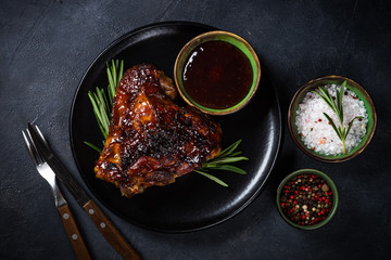 Baked turkey thigh with sauce and herbs.