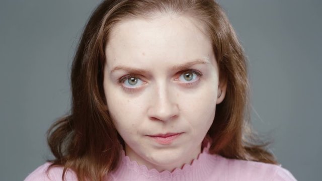 Video of angry woman in pink turtleneck, portrait