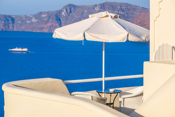 Sea view from hotel terrace with umbrella and coffee table. Amazing sea view from Santorini island...