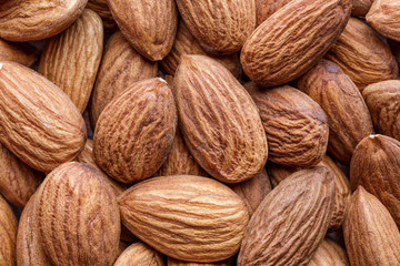 Organic almond nuts as background, top view. Healthy snack. For vegetarians.