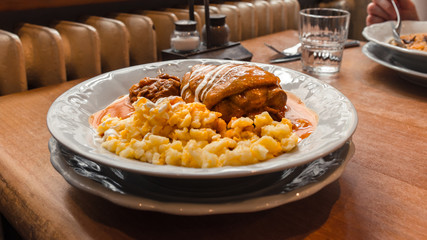 A plate of the traditional Hungarian chicken drumstick paprikash with egg noodles.