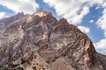 The beautiful view of blue sky and snow mountain summit near to Alaudin lake in Fann mountains in Tajikistan
