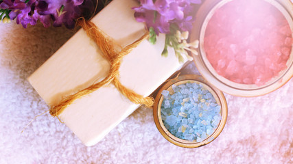 Fototapeta na wymiar Red sea salt and purple flowers, white soap for beauty and health