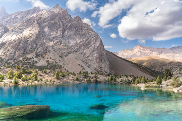 The beautiful mountain trekking road with clear blue sky and rocky hills and the view of Alaudin...