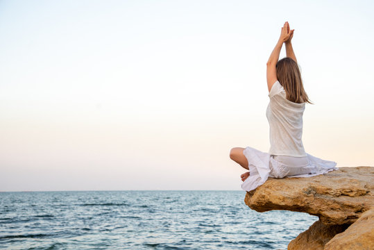 Serenity And Yoga Practicing At The Sea. Sunrise