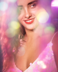 Woman looking away and blurred sparkles effect