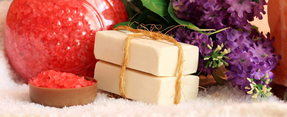 Red sea salt and purple flowers, white soap for beauty and health