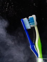 Toothbrushes in glass on table on light background healthcare, clean, healthy, dental, care, lifestyle, health, hygiene