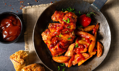 Rustic chicken wings in honey with potato wedges
