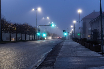 City landscape at foggy night. Long exposure. Light trails.