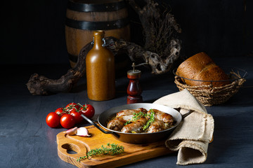 Homemade white sausage fried with onion and herbs