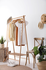Rack with stylish women's clothes indoors. Interior design