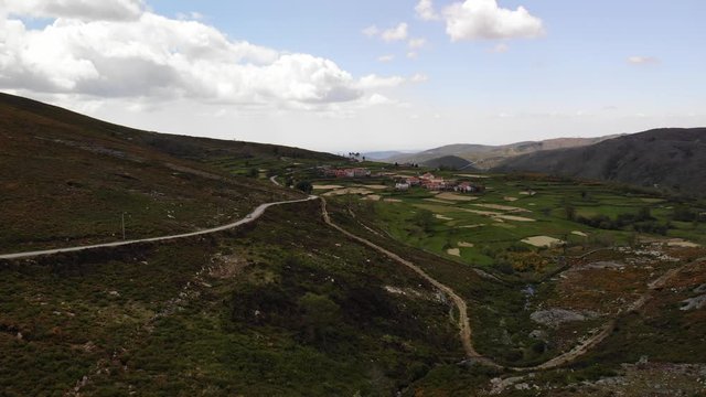 Small car driving up the street in the mountains