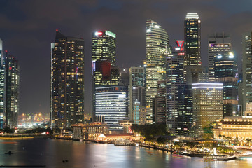 Fototapeta premium Picturesque panoramic view of Singapore city at night time. Financial and trading center hub in Asia region. Concept of success. Modern buildings in high-tech world.