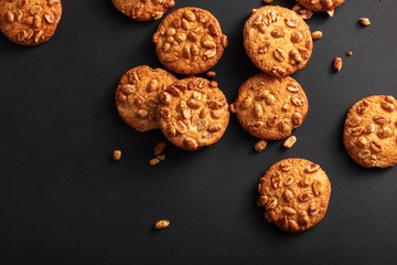 Background from cookies with nuts top view. The dark background and cookies with crumbs on a black background.